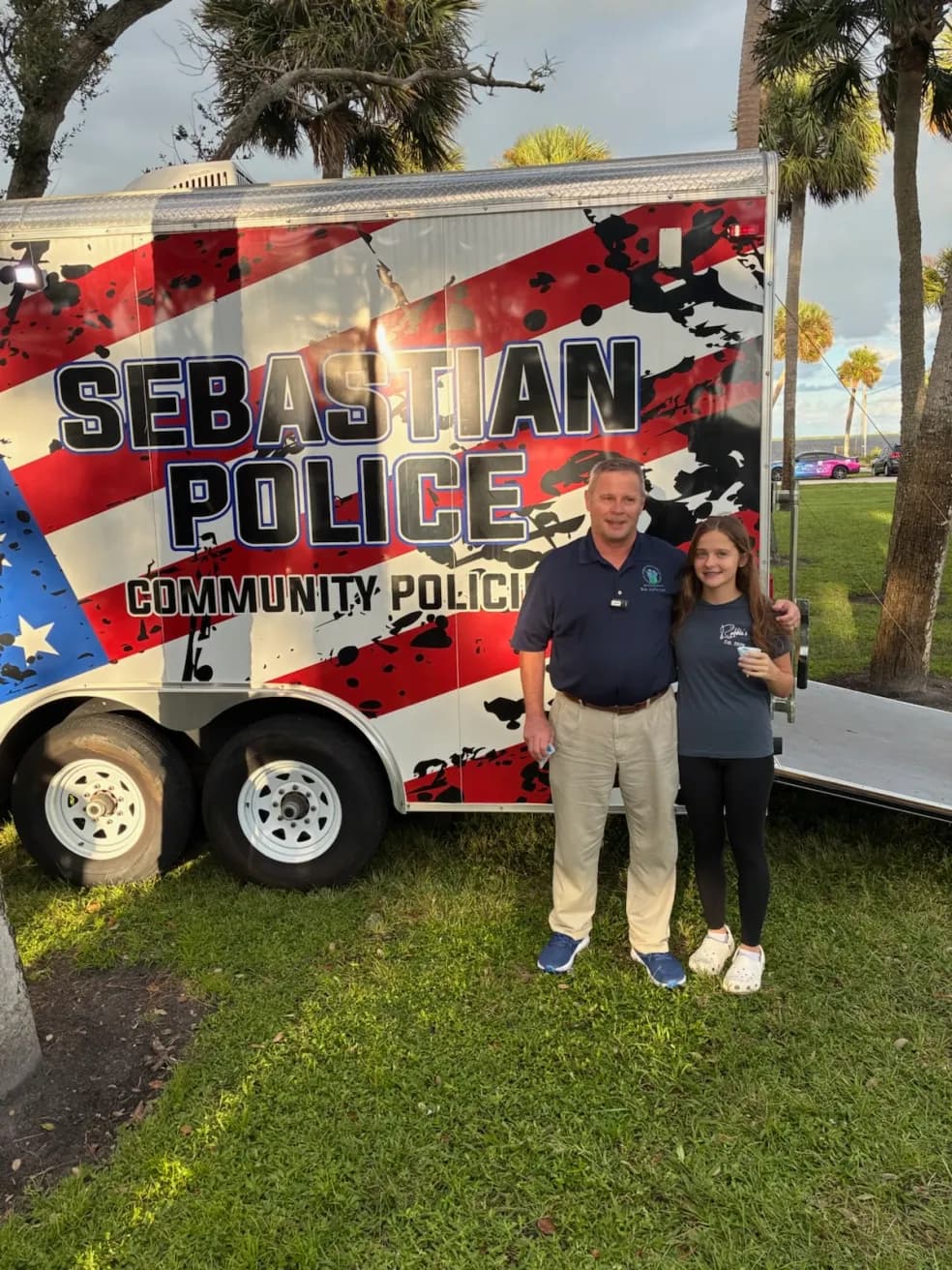 Bob McPartlan and his daughter at a police community trailer
