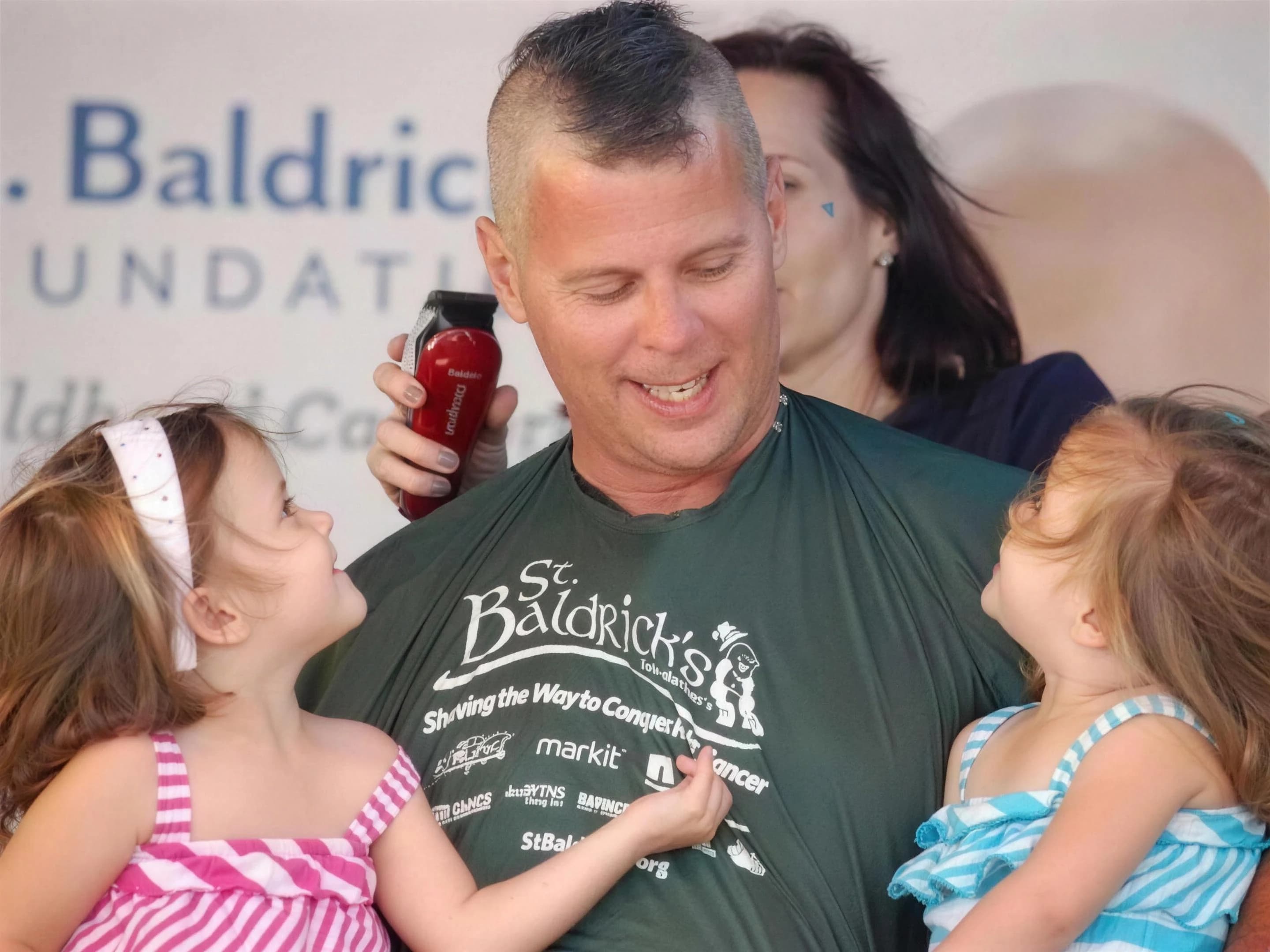 Bob McPartlan with his daughters at a St. Baldrick's charity event