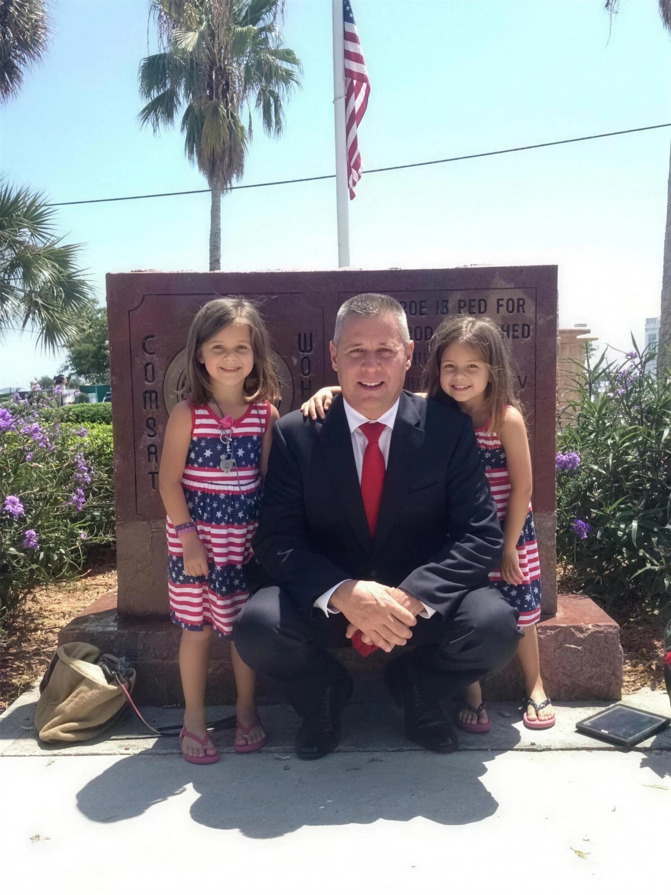 Bob McPartlan with his daughters at a memorial event